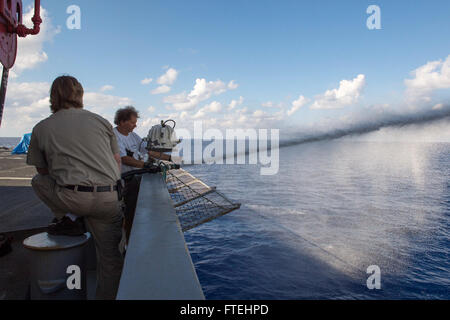Cette image montre des marins de l'US Navy qui testent le système de mousse filmogène aqueux à bord de l'USNS Leroy Grumman, un huileur de réapprovisionnement de flotte. Le navire, déployé en mer Méditerranée, joue un rôle clé dans les opérations militaires américaines, assurant la préparation et la sécurité dans la région. Banque D'Images