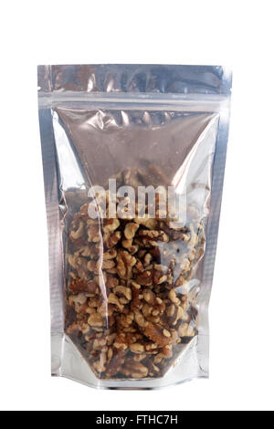 Les noix dans l'emballage aluminium sacs à fermeture zip. Isolé sur blanc avec des chemins de détourage. Banque D'Images