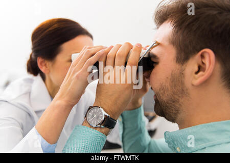 Opticien avec pupillometer et patient à la clinique Banque D'Images