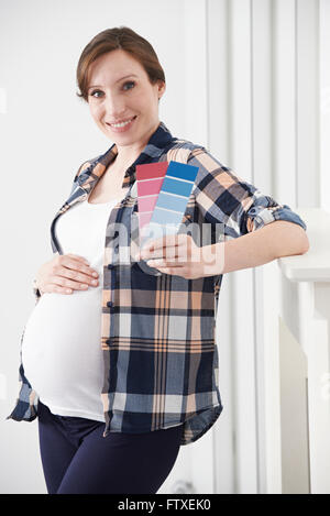 Femme enceinte le choix de couleurs Fort chambre de bébé Banque D'Images