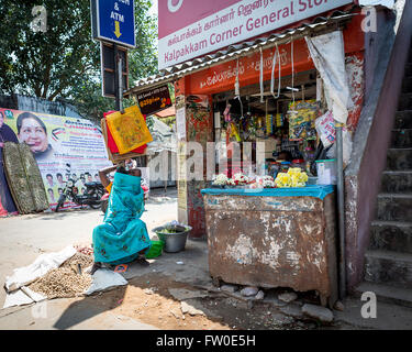 Femme vendant des arachides, des fleurs et des marchandises générales à Kalpakkam Corner magasin général, Tamil Nadu, Inde Banque D'Images