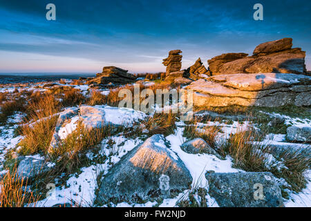 Lever de soleil spectaculaire sur la colline rocheuse à la montagne matin neigeux dans la région de Dartmoor National Park, Devon, UK. Banque D'Images