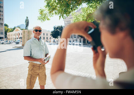 Senior man posing for photo. L'homme photographié par sa femme en vacances. Banque D'Images