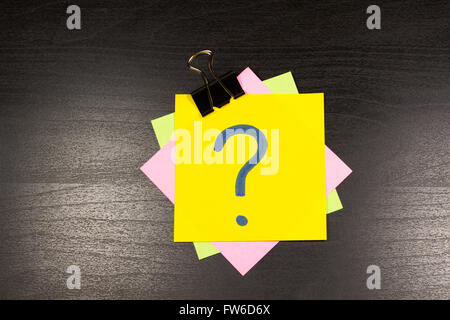 Point d'interrogation sur un post-it sur fond de bois Banque D'Images