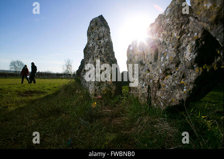 Les marcheurs en prenant un tour du cercle de pierre pierres individuelles et connu comme le 'Rollright Stones', un cercle de pierre de l'époque néolithique sur le sommet d'une colline dans l'Oxfordshire, UK. Le cercle de pierres a été faite faite par l'homme autour de 2500 à 2000 ans avant JC. Banque D'Images