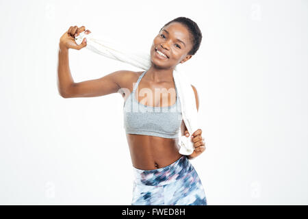 Heureux lovely young african american sportswoman standing et posant avec serviette sur fond blanc Banque D'Images