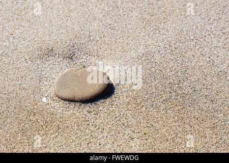 Une grande pierre est assis sur un sable fin à la plage dans l'Oregon, le long de la côte. Banque D'Images