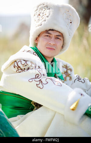 Portrait de l'homme sur l'herbe en vêtements traditionnels looking at camera Banque D'Images