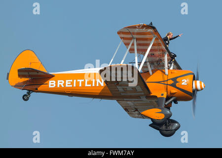 Breitling Wing Walkers dans leurs biplans Boeing Stearman orange vintage. Banque D'Images