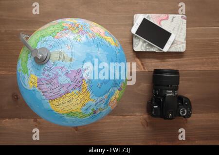 Elche, Espagne. 31 mars 2016 : Globe, appareil photo et mobiles sur fond de bois Banque D'Images