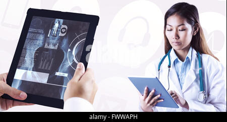 Composite image of doctor using tablet Banque D'Images