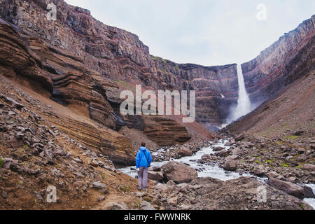 Randonneur marchant à la Hengifoss cascade dans l'Islande, de beaux paysage extraordinaire Banque D'Images