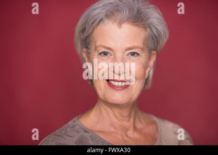 Seior Happy woman in front of white background Banque D'Images