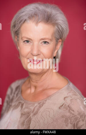 Seior Happy woman in front of white background Banque D'Images