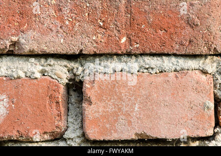 Détail de trois briques et ciment wall background. Banque D'Images