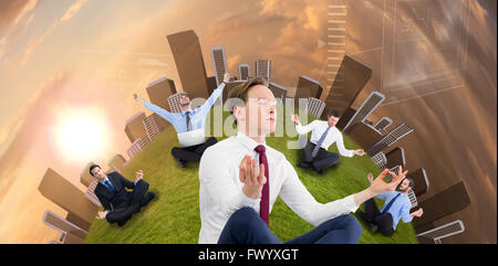 Businessman sitting Zen yoga pose Banque D'Images