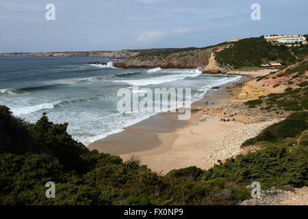 Les rouleaux de l'Atlantique surf dans une baie sur l'Algarve près de Sagres au Portugal. Pratiques d'une école de surf dans les eaux peu profondes. Banque D'Images