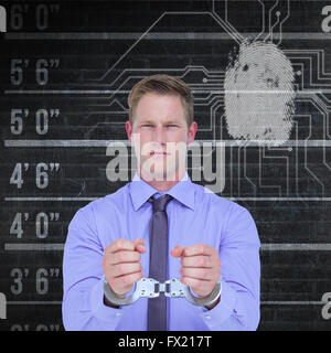 Image composite de handsome businessman wearing handcuffs Banque D'Images