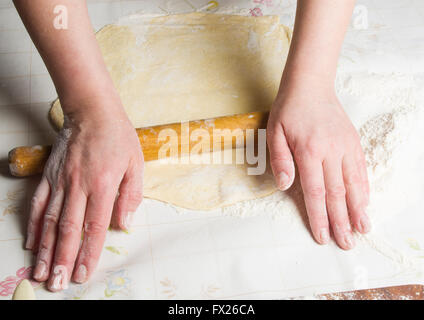 Prendre la pâte par les mains sur fond de table blanc Banque D'Images