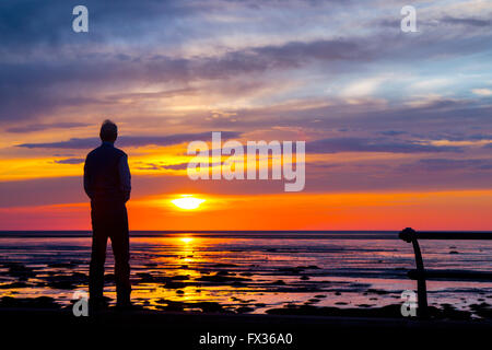 Southport, Merseyside, Royaume-Uni. 10 avril, 2016. Météo britannique. Coucher du soleil sur la mer d'Irlande comme vu de Southport promenade du front de mer donnant sur la grande plage de la station avec des reflets du soleil couchant. Il vient comme un temps plus chaud se déplace dans. Les températures sont mis à grimper et les choses seront glaciaire par le peuvent les jours fériés. Privé prévoient des températures pourrait atteindre 28 degrés et dire que cette année pourrait être le pays le plus chaud du printemps et l'été. Banque D'Images