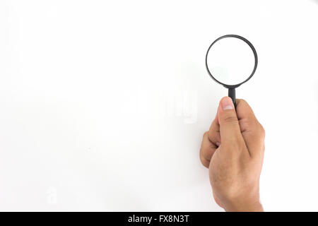 Hand Holding Magnifying Glass Against White Background Banque D'Images