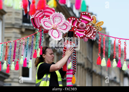 Bath, Royaume-Uni, le 14 avril, 2016. Les bénévoles dirigé par Emma Leith illustrés dans Milsom Street comme ils l'enrouler de la laine lampadaires dans le cadre d'un fil de bienfaisance au profit de la bombe RUH Cancer Care Appel. Pour chaque poster enveloppé avec de la laine, Mulberry a promis €100 à l'organisme de bienfaisance.L'événement kick démarre la semaine de la mode en 2016 baignoire,la semaine fête de la mode commence le 18 avril. Credit : lynchpics/Alamy Live News Banque D'Images