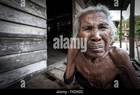 La Birmanie, Myanmar, une vieille femme aux cheveux blancs et la peau froissée tanné. Banque D'Images