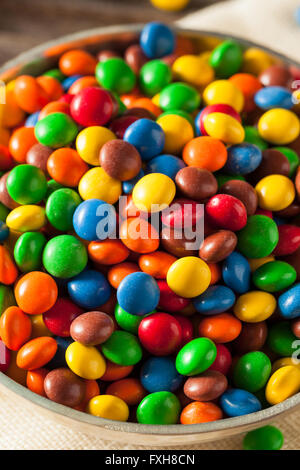 Couleurs arc-en-ciel enrobée de morceaux de chocolat dans un bol Banque D'Images