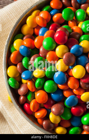 Couleurs arc-en-ciel enrobée de morceaux de chocolat dans un bol Banque D'Images