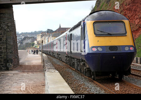 Vue rapprochée d'un moteur diesel et des voitures qui passent sous une passerelle après avoir quitté la station de Dawlish Banque D'Images