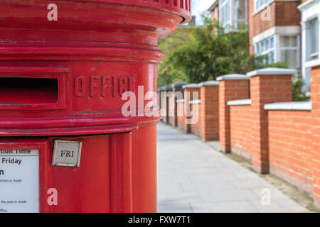 Post box traditionnelle britannique contre l'arrière-plan flou chambre terrasse Banque D'Images