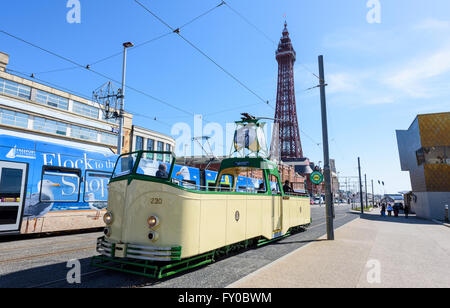 Sous un ciel bleu, un tramway moderne et un patrimoine tram passent devant la célèbre Tour de Blackpool de Blackpool, Lancashire Banque D'Images