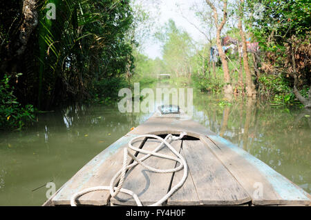 L'avant d'un bateau en bambou en traversant une forêt de mangrove dans le delta du Mékong au Vietnam du Sud. Banque D'Images