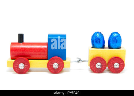 Chemin de fer modèle en bois coloré avec les oeufs de Pâques sur wagons de marchandises, isolé Banque D'Images