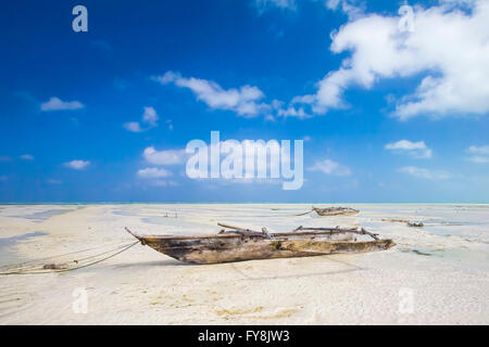 En Dhow bateau poisson pond au sec pendant la marée basse sur une plage de l'Océan Indien près de Zanzibar, Tanzanie Banque D'Images