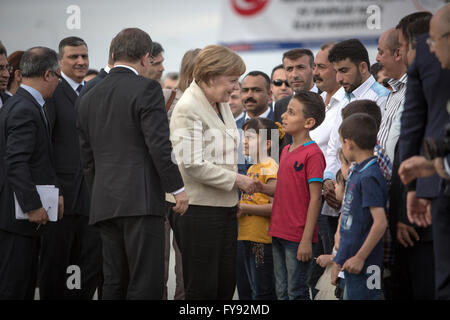 Gaziantep, Turquie. Apr 23, 2016. La chancelière allemande Angela Merkel (C) et le Premier ministre turc Ahmet Davutoglu (3L) visite le camp de réfugiés de Nizip Nizip, Gaziantep, Turquie, le 23 avril 2016. Merkel et haut fonctionnaires de l'Union européenne, sous la pression de réévaluer une expulsion de migrants face à la Turquie, se déplacent près de la frontière avec la Syrie dans le but de renforcer l'accord. Dpa : Crédit photo alliance/Alamy Live News Banque D'Images