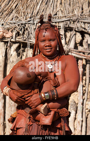 Les himbas sont un peuple nomade de la Namibie. Ils se parer avec cuir et anneaux en laiton et enduire la peau avec une pâte faite de beurre et du bois. Filles portent deux épaisses tresses tresse, face avant et se redressa au-dessus du front comme des cornes, Namibi Banque D'Images