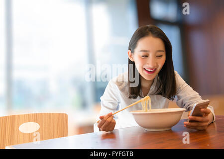 Businesswoman having noodles Banque D'Images