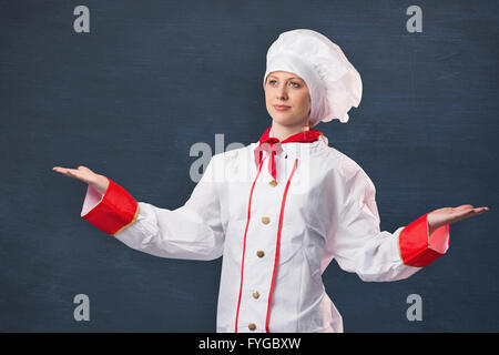 Image composite de jolie chef standing with hands out Banque D'Images