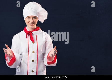 Image composite de jolie chef standing with hands out Banque D'Images