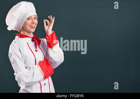 Image composite de jolie chef standing with arms crossed Banque D'Images