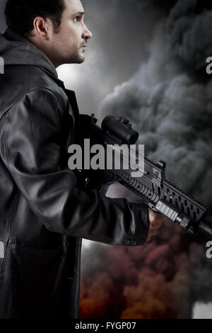 Homme aux longues veste en cuir et fusil d'assaut, fumée noire background