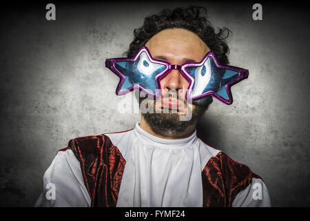 Homme stupide avec des lunettes et des gestes gracieux parti ridicule Banque D'Images