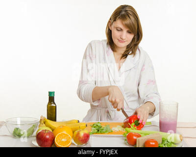 Jeune fille coupe salade végétarienne poivre Banque D'Images