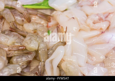 La variété des fruits de mer frits dans une vitrine avec de la vapeur destinée à la vente sur le marché. Image avec du brouillard sur une étagère en verre Banque D'Images