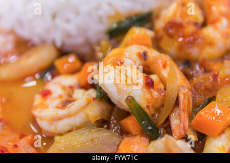 Sauté de crevettes au curry rouge thaï avec du riz et œuf frit frit épicé , Crevettes , crevettes frites au curry et riz cuit dans Banque D'Images