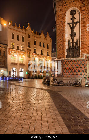 La Pologne, la ville de Cracovie pendant la nuit, la place Mariacki pavées de la vieille ville, Tenement House, St Mary Basilique, l'église (à droite), hist Banque D'Images