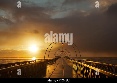 Southport, Merseyside, UK 28 avril, 2016. Météo britannique. Unseasonal les conditions météorologiques de la grêle et neige sur la mer d'Irlande et jetée victorienne au coucher du soleil. Banque D'Images