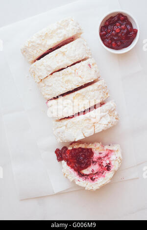 Roulade de meringue avec canneberges sauce aux canneberges. Vue d'en haut, l'image aux couleurs vintage, espace blanc Banque D'Images