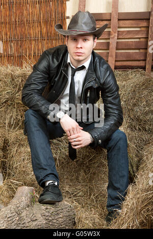 Beau cowboy dans blouson de cuir dans les régions rurales de l'intérieur. Banque D'Images